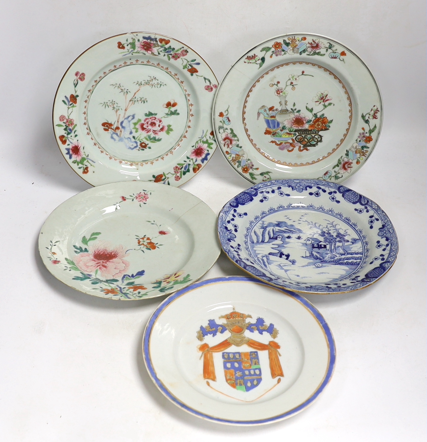 Four 18th century Chinese porcelain plates, and a later armorial plate, 21.5cm